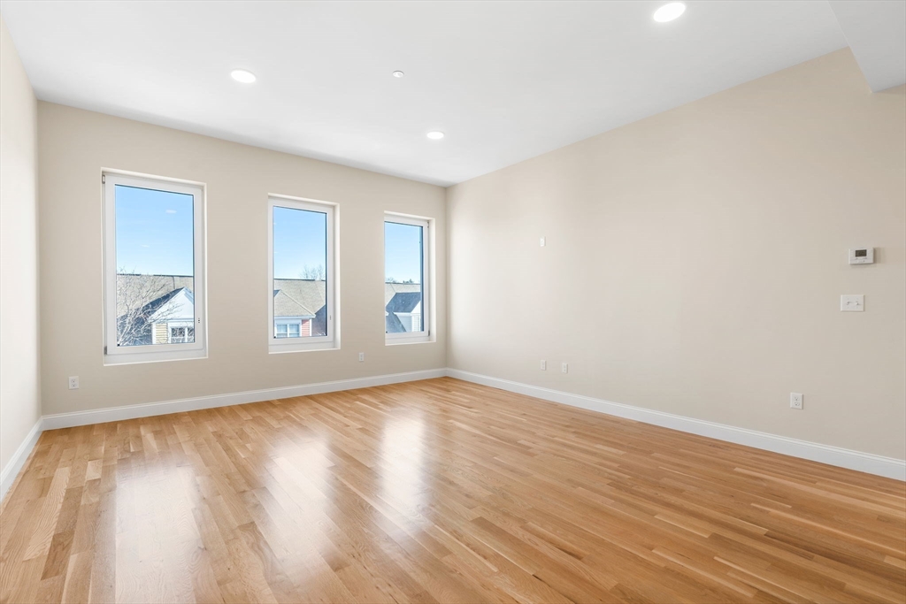 16 Taber Street, Unit 304 Boston, MA 02119 - Photo 3 of 11 a view of room with window and wooden floor