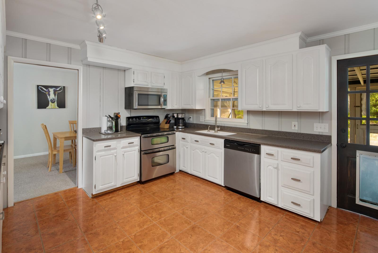 2413 Porter Road Nashville, TN 37206 - Photo 13 of 29 a kitchen with granite countertop white cabinets and white appliances