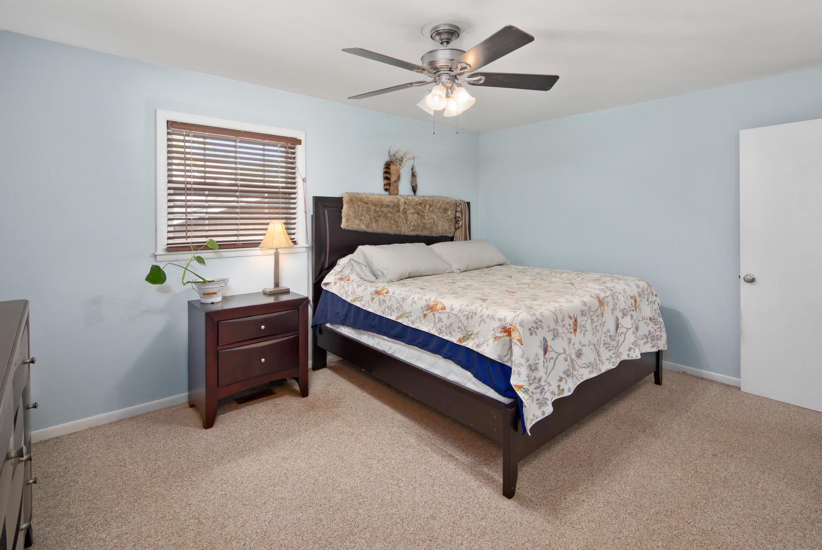 2413 Porter Road Nashville, TN 37206 - Photo 18 of 29 a bedroom with a bed and a chandelier