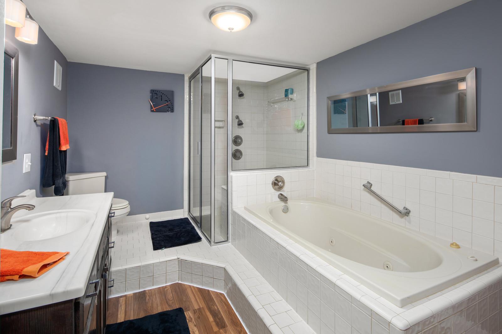 2413 Porter Road Nashville, TN 37206 - Photo 24 of 29 a bathroom with a tub sink a mirror and a shower