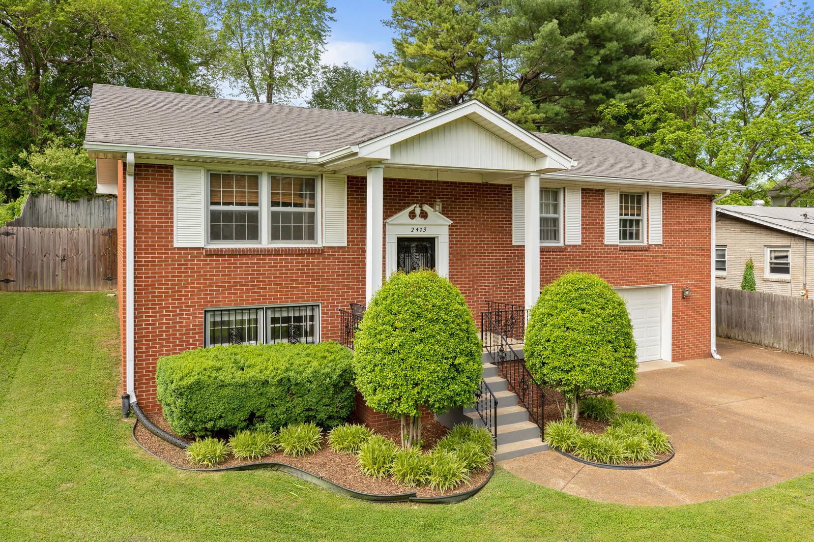 2413 Porter Road Nashville, TN 37206 - Photo 3 of 29 a front view of a house with a yard