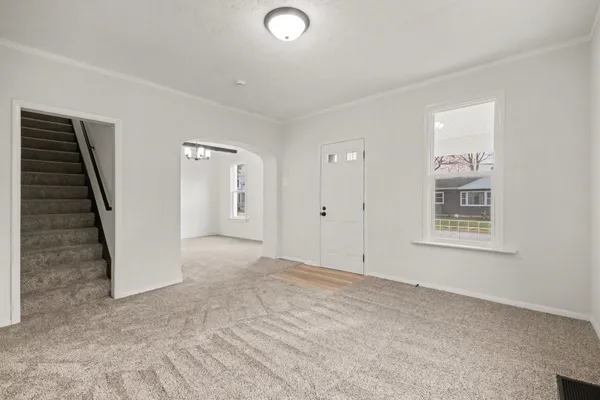 an empty room with windows and closet