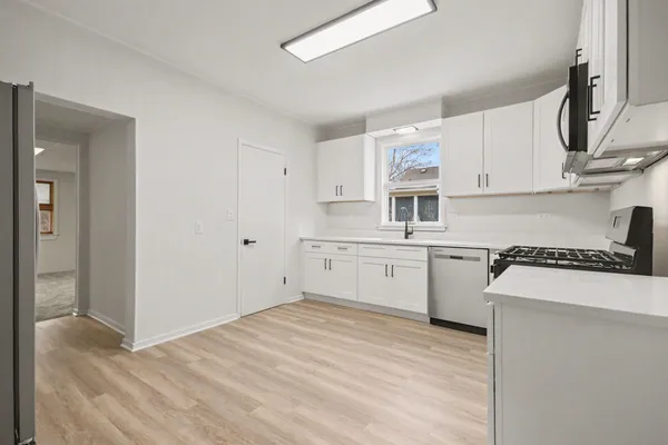 a kitchen with a stove a sink and a refrigerator