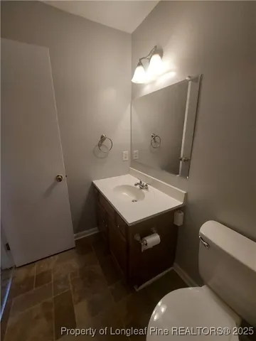 a bathroom with a sink toilet and mirror