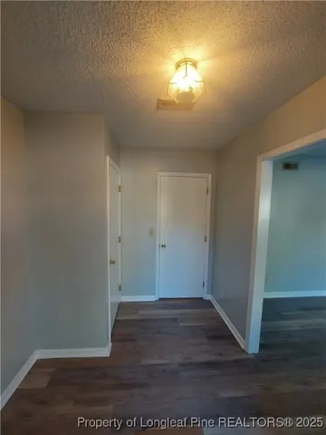 an empty room with wooden floor sink and closet