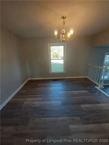 a view of room with wooden floor