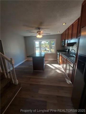 a view of kitchen with cabinets