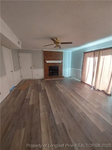 wooden floor in an empty room with a fireplace