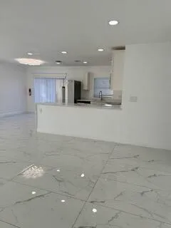 a view of kitchen with kitchen island microwave and stove