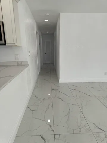 a view of a kitchen with a sink and a stove top oven