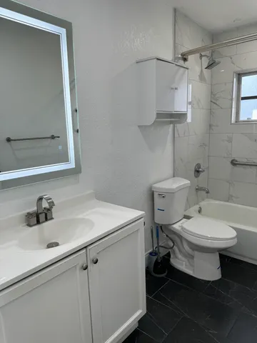 a bathroom with a toilet sink and mirror