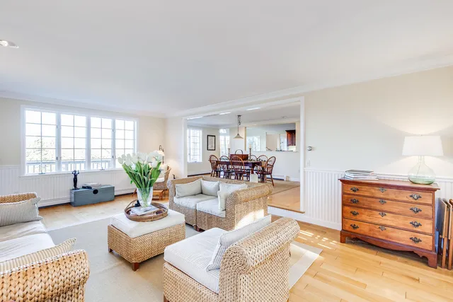 a living room with furniture a couch and potted plant