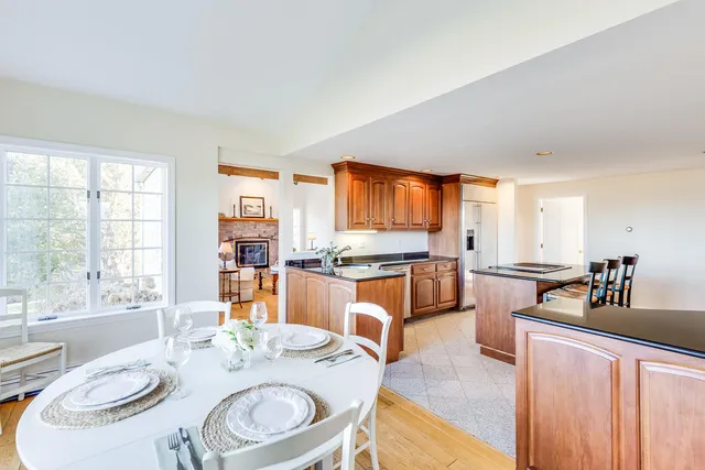 a dining room with granite countertop furniture a large window and a sink