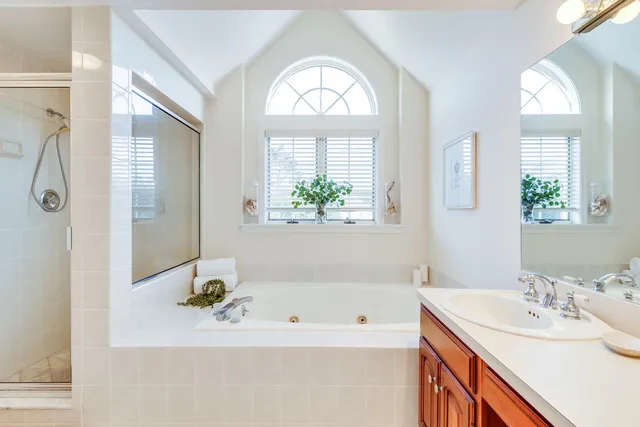 a bathroom with a bathtub a sink and a window