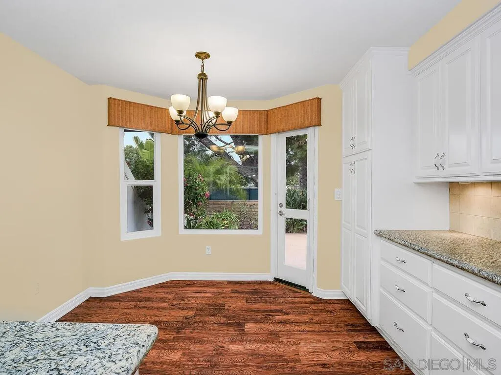 4708 Galicia Way Oceanside, CA 92056 - Photo 13 of 44 a view of an entryway with window and wooden floor