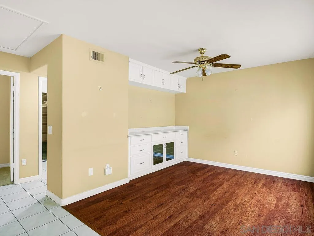4708 Galicia Way Oceanside, CA 92056 - Photo 18 of 44 a view of empty room with a fireplace and wooden floor
