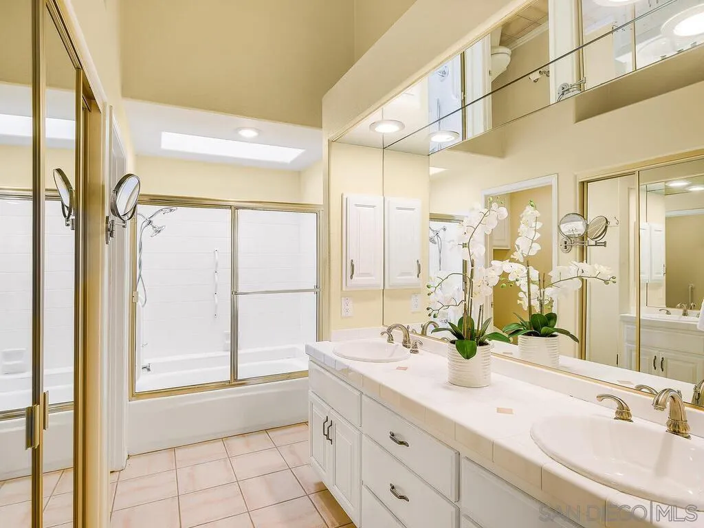 4708 Galicia Way Oceanside, CA 92056 - Photo 23 of 44 a bathroom with a double vanity sink mirror and next to a window