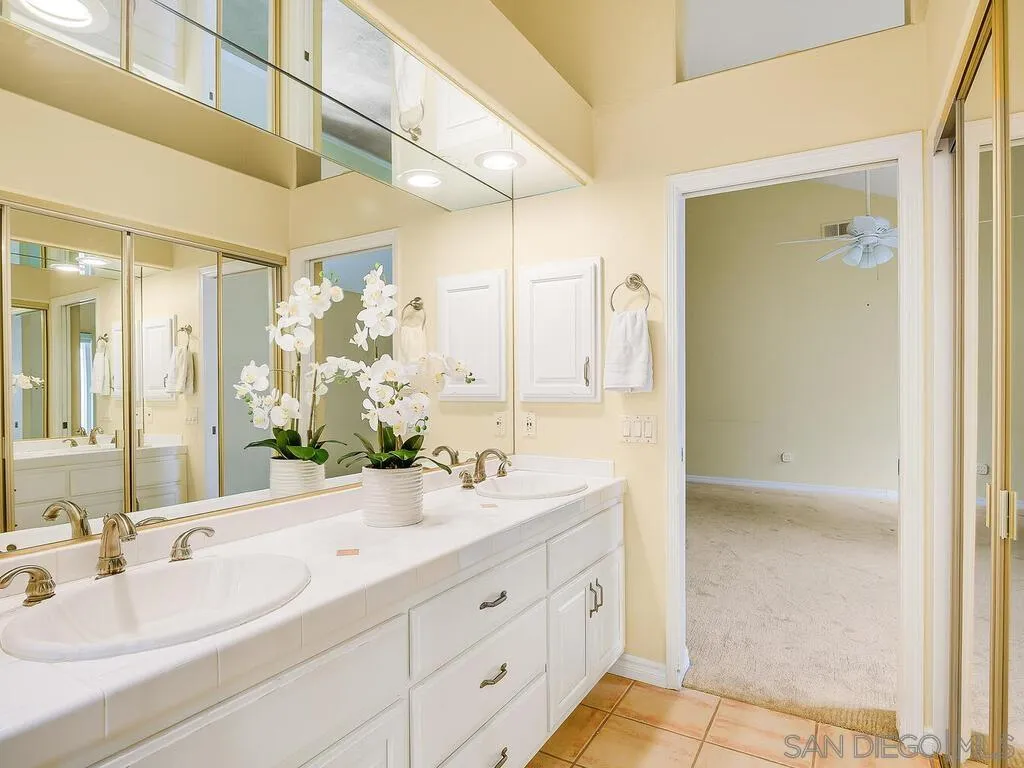 4708 Galicia Way Oceanside, CA 92056 - Photo 24 of 44 a bathroom with a double vanity sink mirror and double
