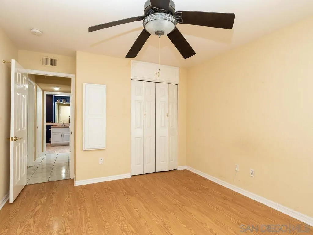 4708 Galicia Way Oceanside, CA 92056 - Photo 27 of 44 a view of empty room with wooden floor