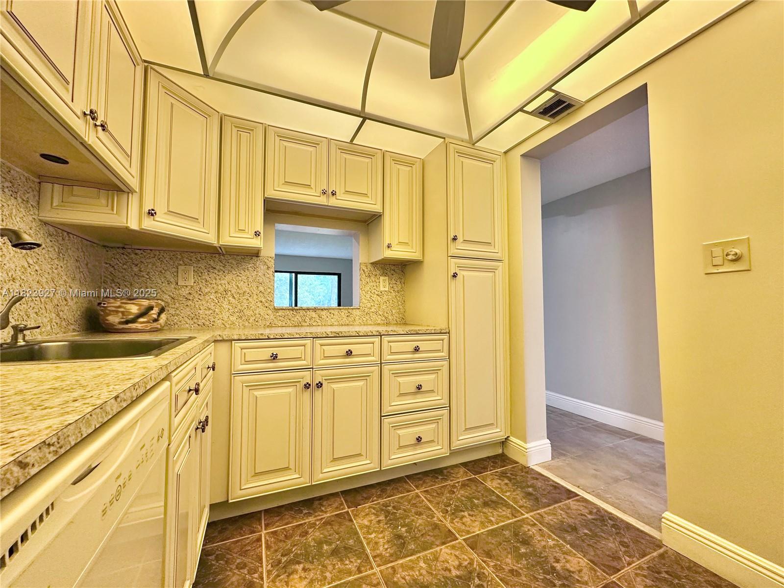 8001 Fairview Drive, Unit 107 Tamarac, FL 33321 - Photo 12 of 33 a bathroom with a granite countertop sink and washing machine