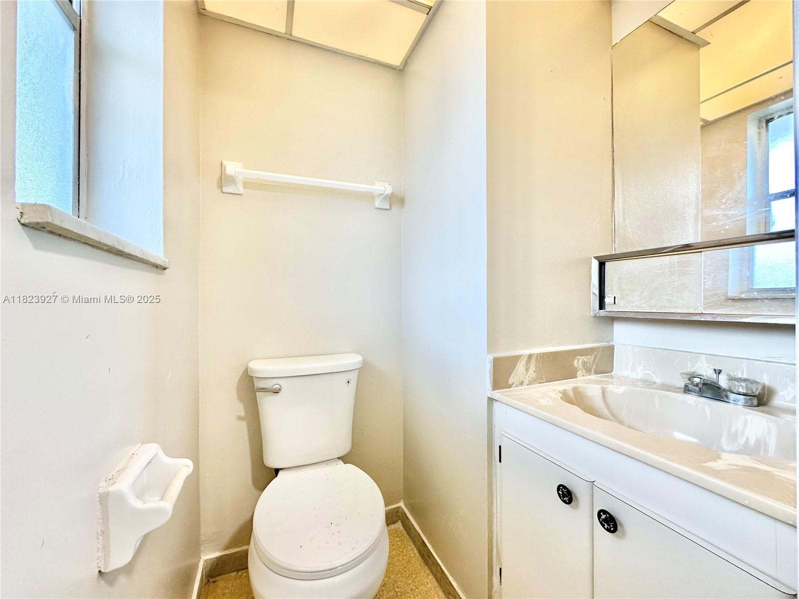 8001 Fairview Drive, Unit 107 Tamarac, FL 33321 - Photo 16 of 33 a white toilet sitting next to a bathroom sink