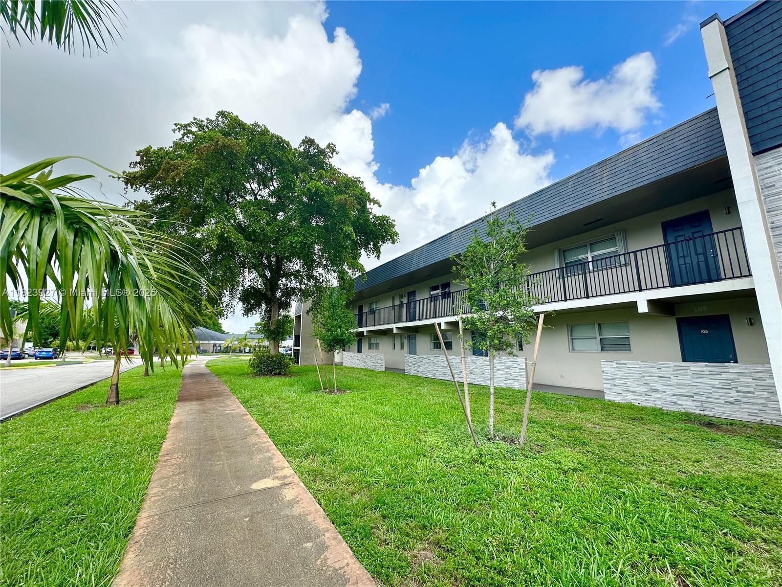8001 Fairview Drive, Unit 107 Tamarac, FL 33321 - Photo 2 of 33 a view of a house with a yard