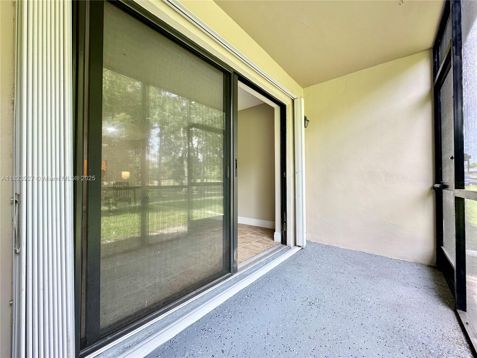 8001 Fairview Drive, Unit 107 Tamarac, FL 33321 - Photo 21 of 33 a view of a glass door and the balcony