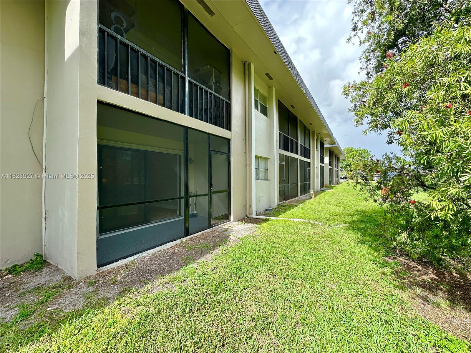 8001 Fairview Drive, Unit 107 Tamarac, FL 33321 - Photo 23 of 33 a view of house with backyard and porch