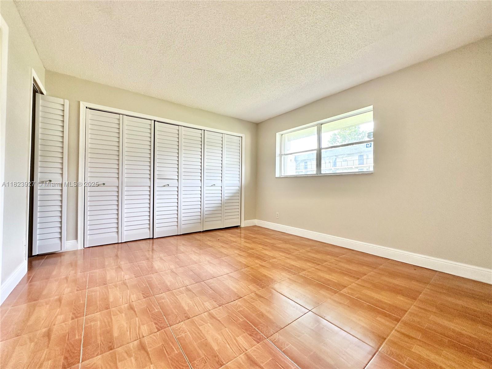 8001 Fairview Drive, Unit 107 Tamarac, FL 33321 - Photo 4 of 33 an empty room with windows
