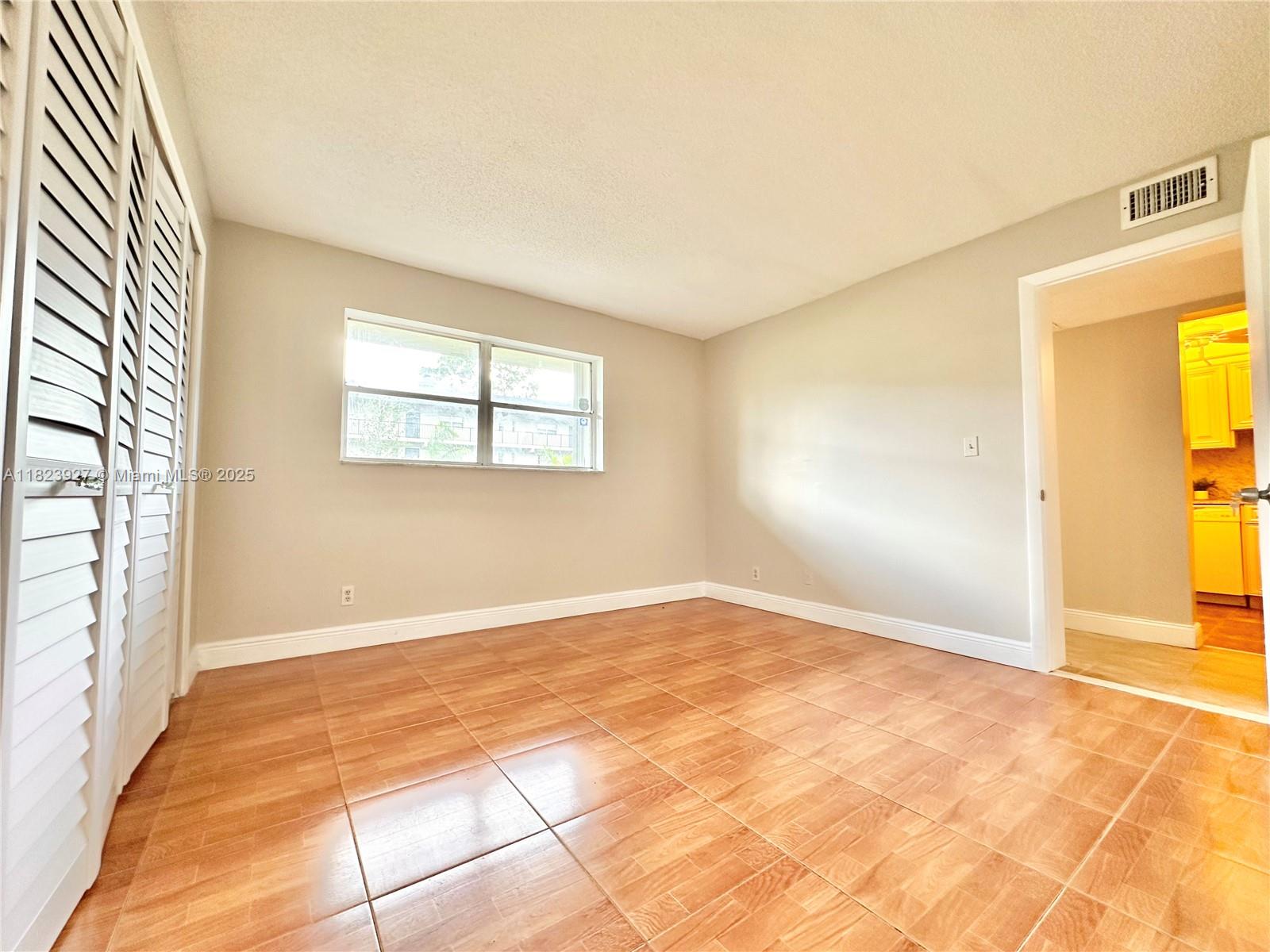 8001 Fairview Drive, Unit 107 Tamarac, FL 33321 - Photo 7 of 33 an empty room with windows
