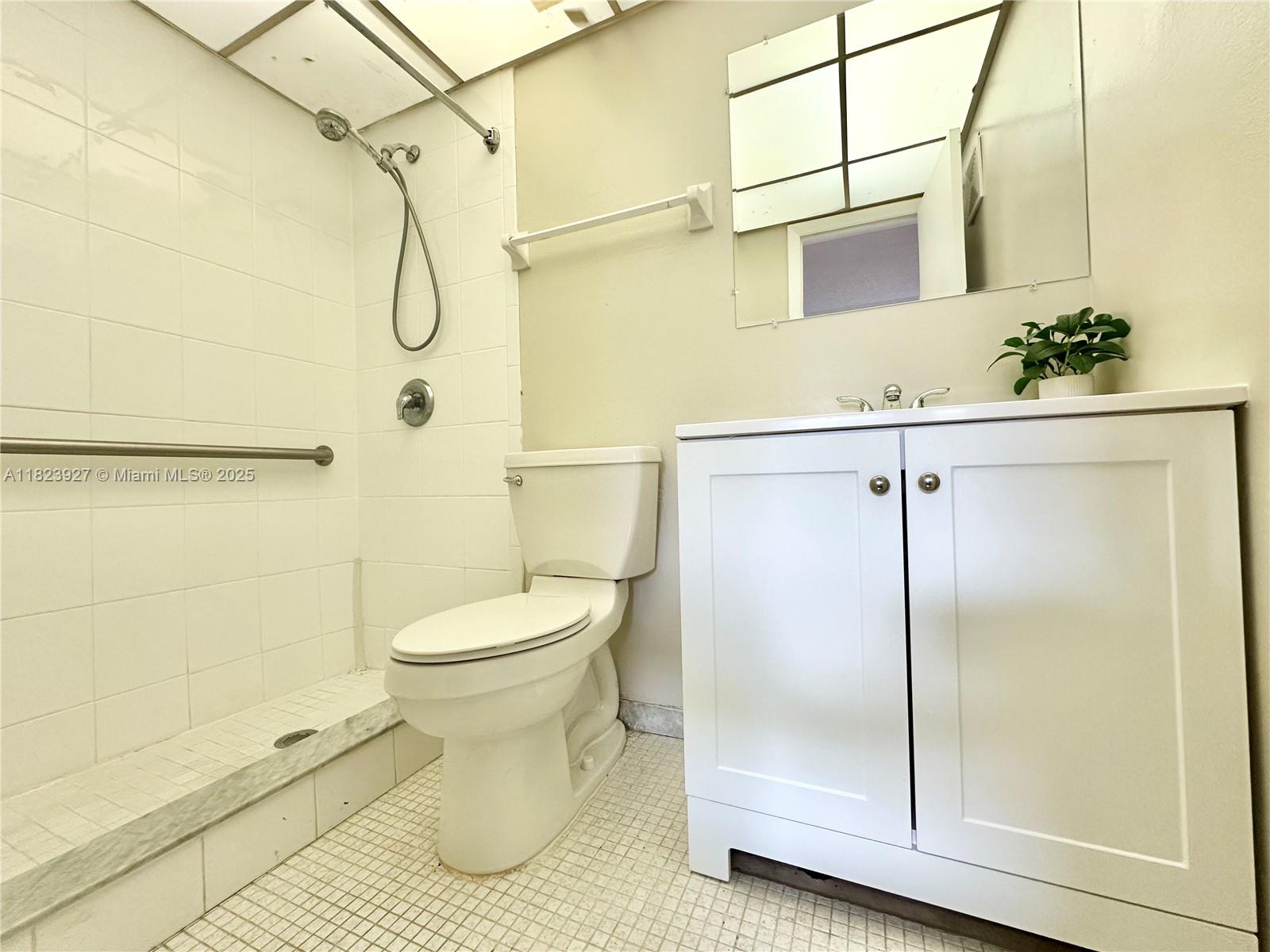 8001 Fairview Drive, Unit 107 Tamarac, FL 33321 - Photo 8 of 33 a bathroom with a sink toilet and shower