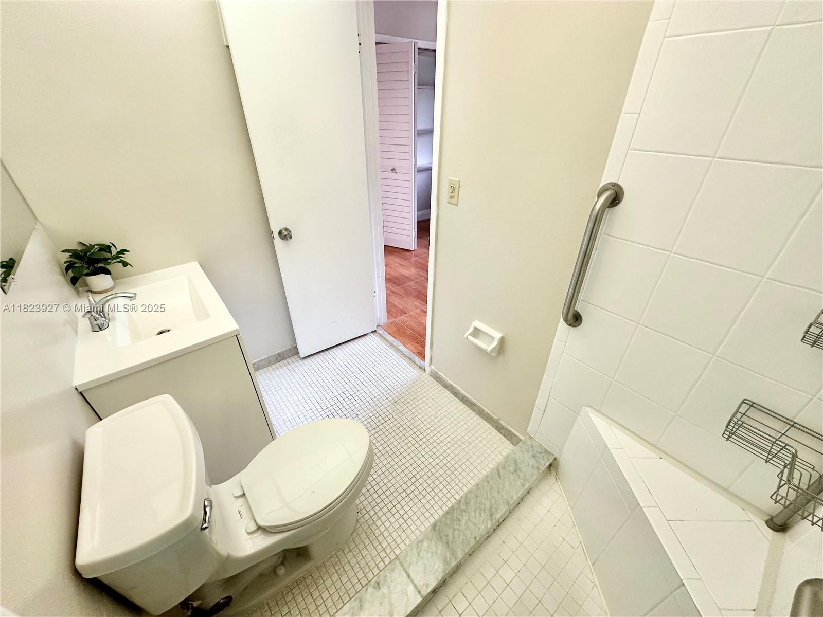8001 Fairview Drive, Unit 107 Tamarac, FL 33321 - Photo 9 of 33 a bathroom with a sink and toilet