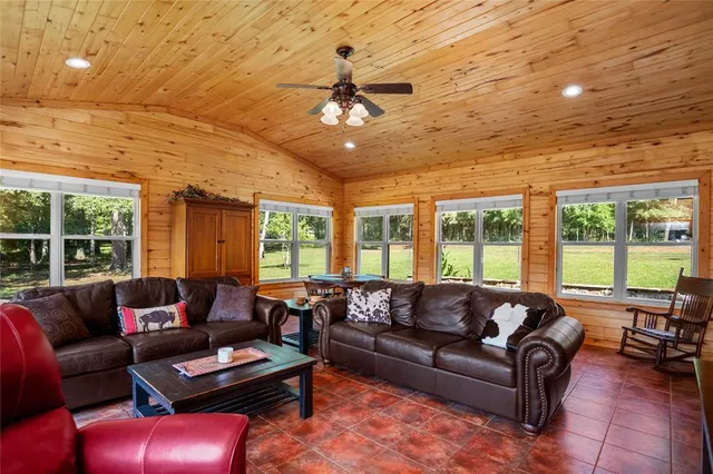 a living room with furniture and a floor to ceiling window
