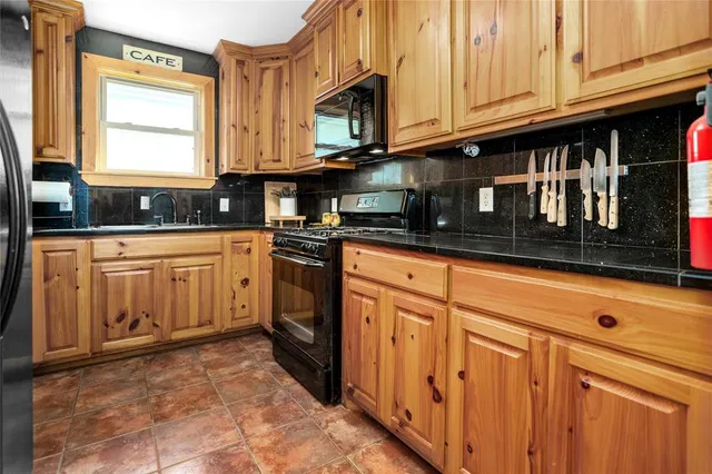 a kitchen with stainless steel appliances granite countertop a stove and a microwave