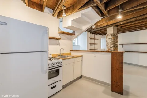 a kitchen with a stove and white cabinets