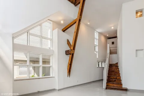 a view of an entryway with wooden floor and staircase