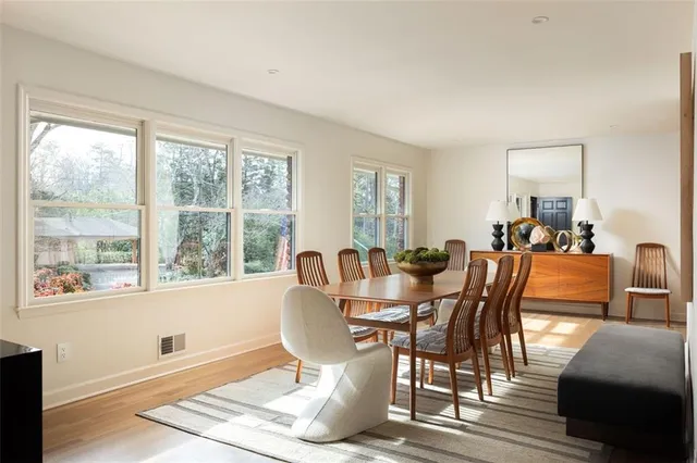 a dining room with furniture a window and wooden floor
