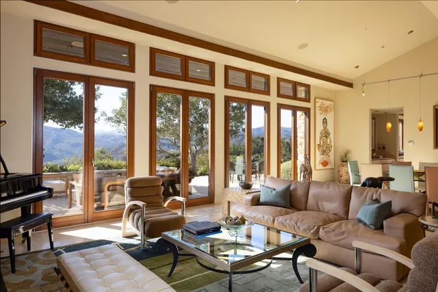 a kitchen with stainless steel appliances granite countertop table chairs and a large window