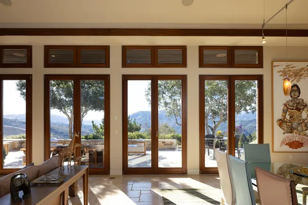 a view of a city from a dining room with large windows