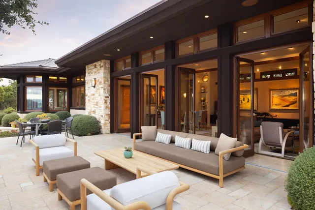 an aerial view of a house with pool table and chairs