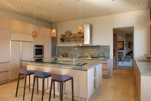 a living room with furniture kitchen view and a large window