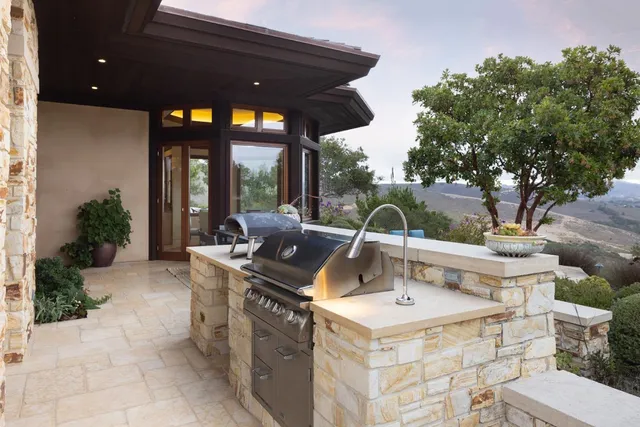 a view of a patio with couches table chairs and potted plants