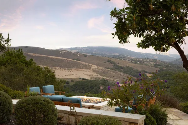 a view of a patio with couches table chairs and potted plants