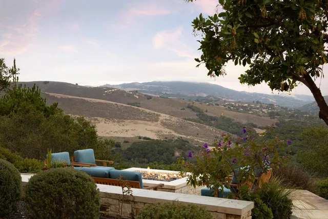 a view of a hallway with wooden floor and windows