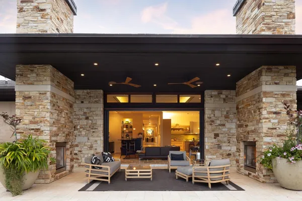a view of a patio with table and chairs