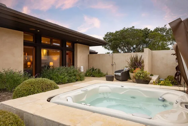 a view of a house with a yard and sitting area
