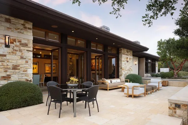 a view of a house with a yard and sitting area