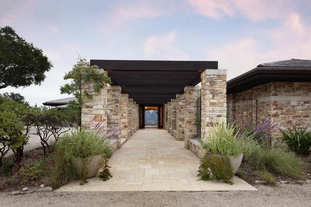 a building outdoor space with patio furniture and potted plants