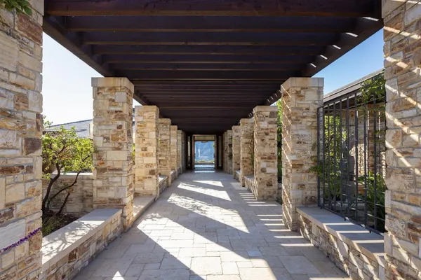 a building outdoor space with patio furniture and potted plants