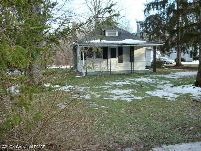 82 Carlton Road Mount Pocono, PA 18344 - Photo 1 of 8 a front view of a house with a garden